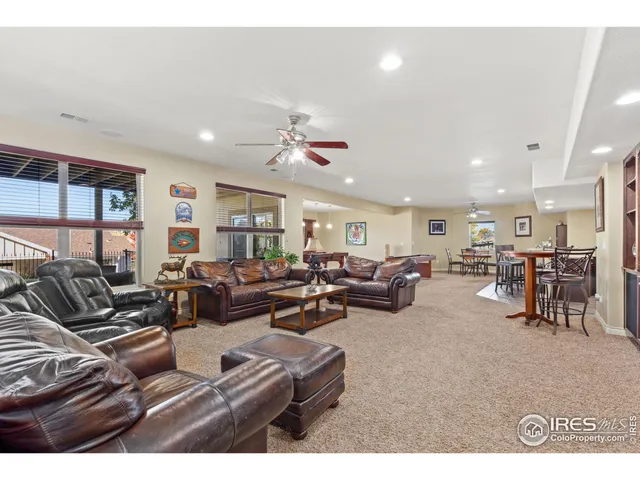 a living room with furniture kitchen view and a window
