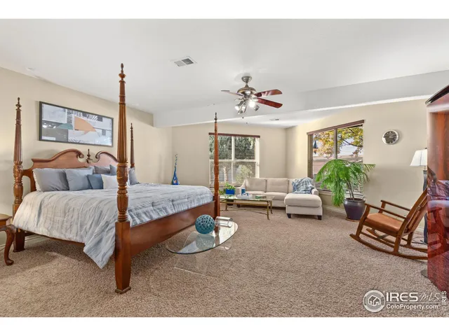 a bathroom with a granite countertop sink two mirror and shower