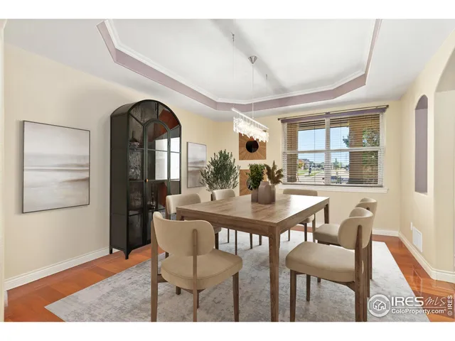 a living room with furniture and a wall painting