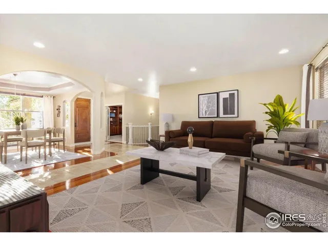a living room with furniture and a dining table