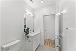 a en suite bathroom with a granite countertop sink and a mirror