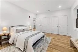 a spacious bedroom with a bed and a lamp