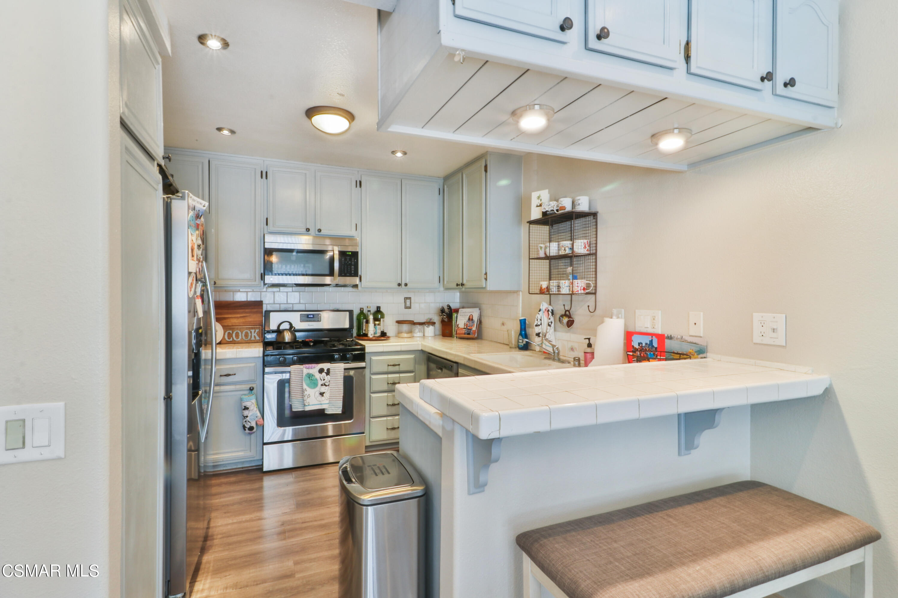 2346 Royal Avenue, Unit 9 Simi Valley, CA 93065 - Photo 15 of 31 a kitchen with a sink a stove and cabinets