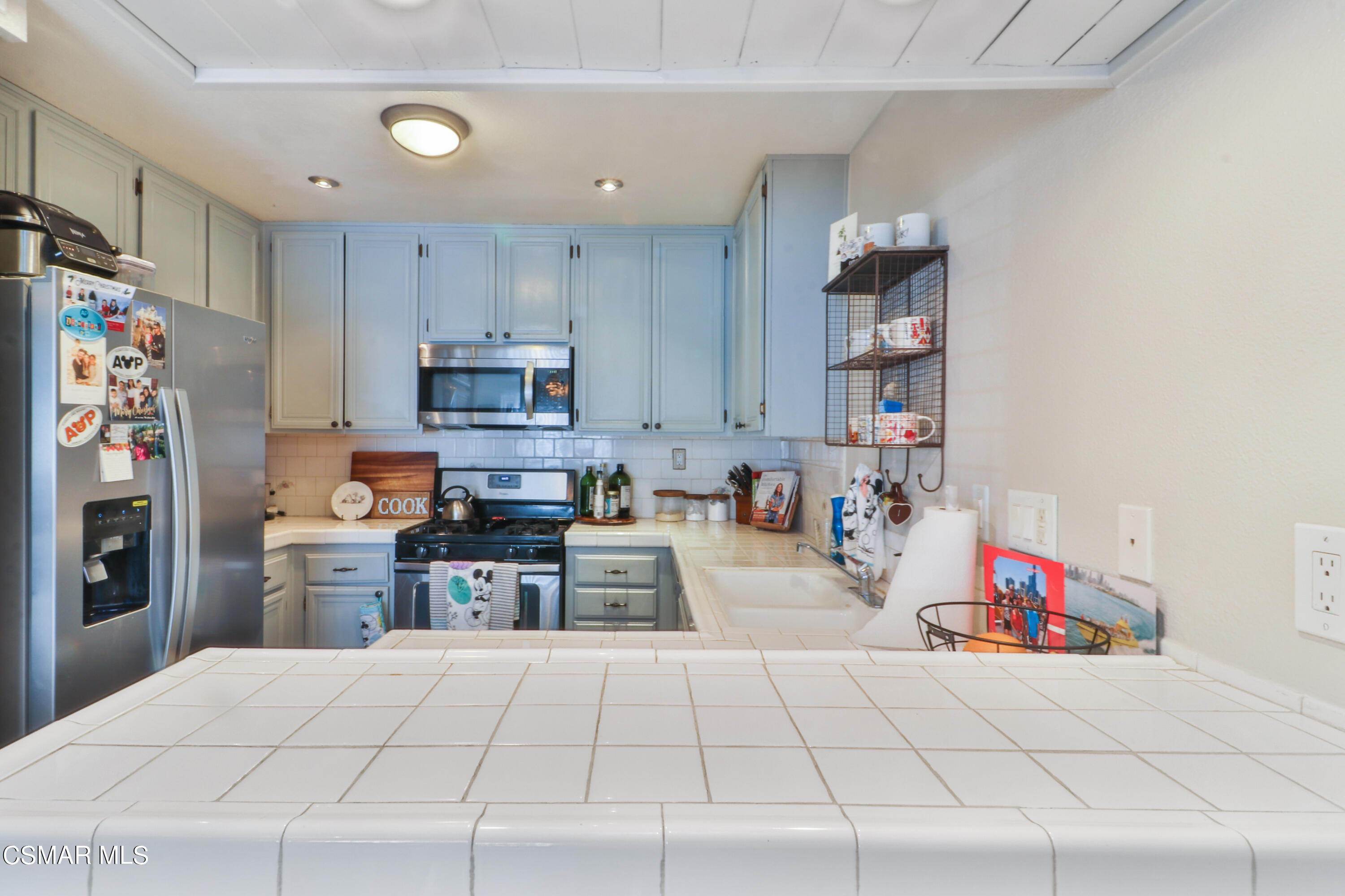 2346 Royal Avenue, Unit 9 Simi Valley, CA 93065 - Photo 16 of 31 a kitchen with refrigerator and cabinets