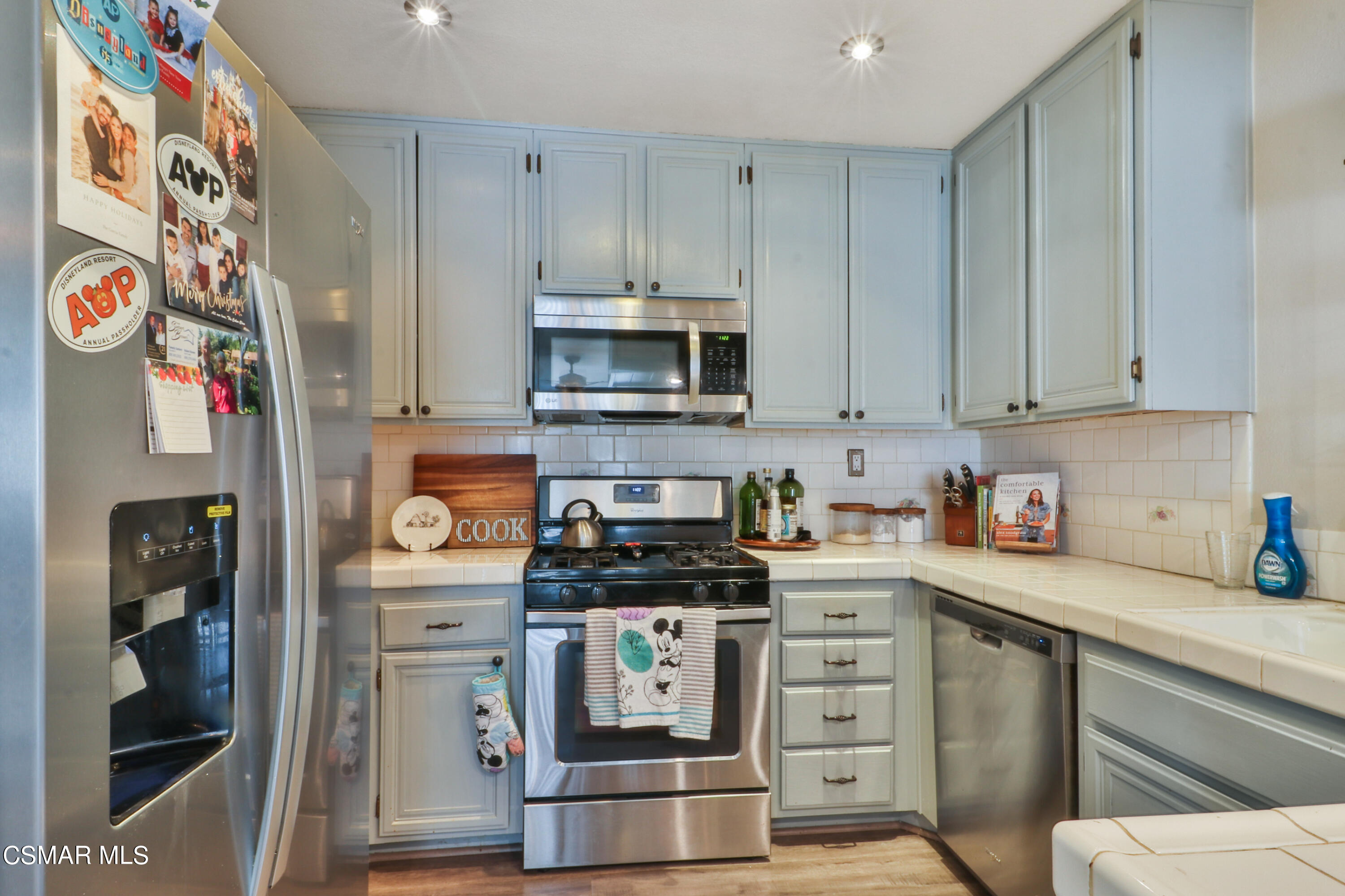 2346 Royal Avenue, Unit 9 Simi Valley, CA 93065 - Photo 17 of 31 a kitchen with stainless steel appliances a stove a microwave and cabinets