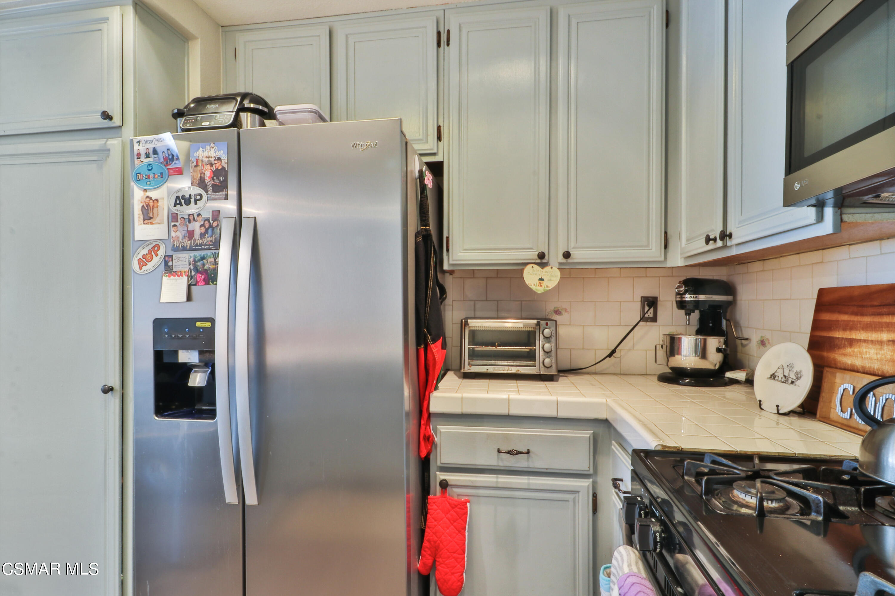 2346 Royal Avenue, Unit 9 Simi Valley, CA 93065 - Photo 19 of 31 a kitchen with a refrigerator and a stove top oven