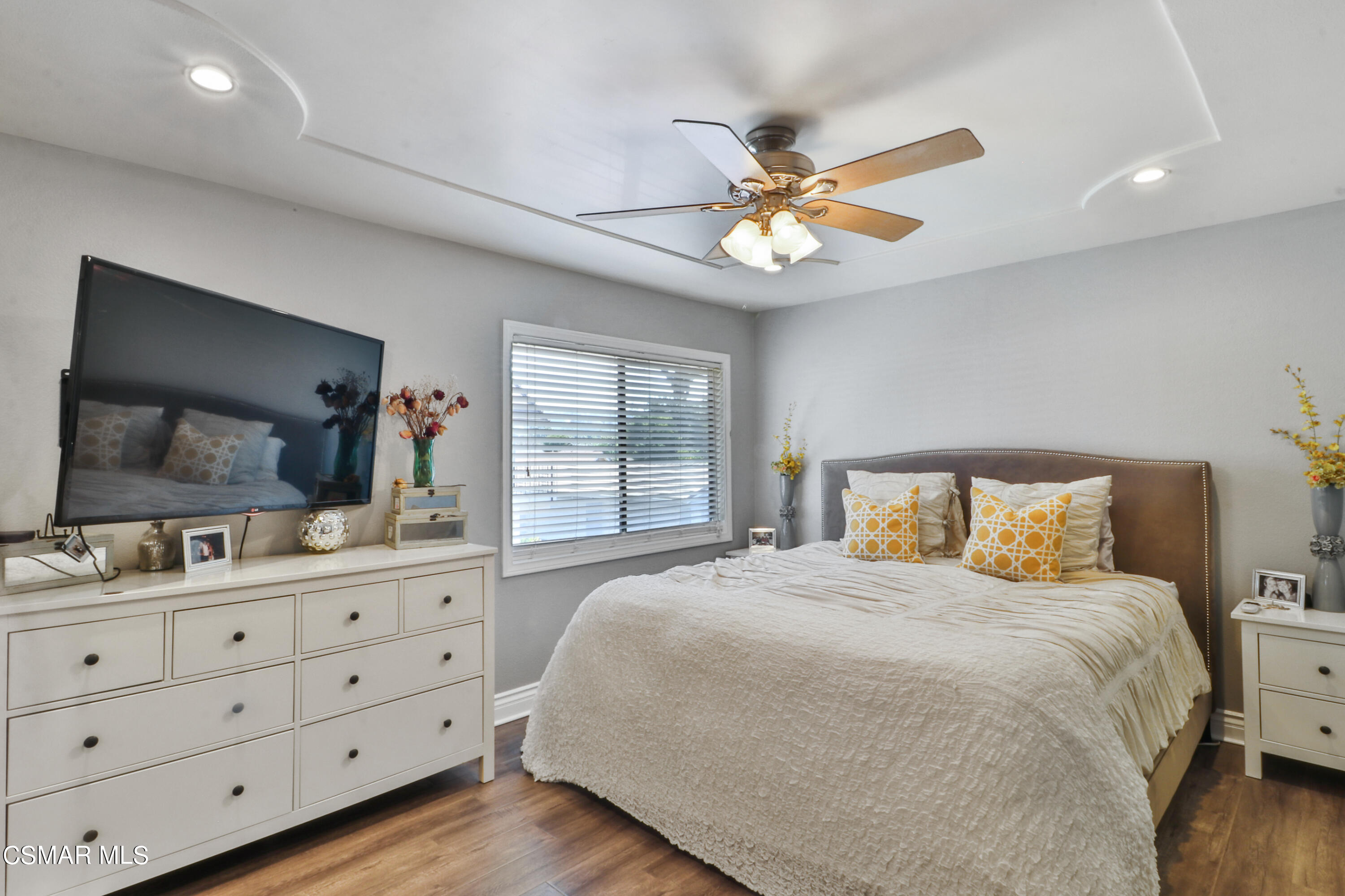 2346 Royal Avenue, Unit 9 Simi Valley, CA 93065 - Photo 24 of 31 a bedroom with a large bed and a flat tv screen on dresser