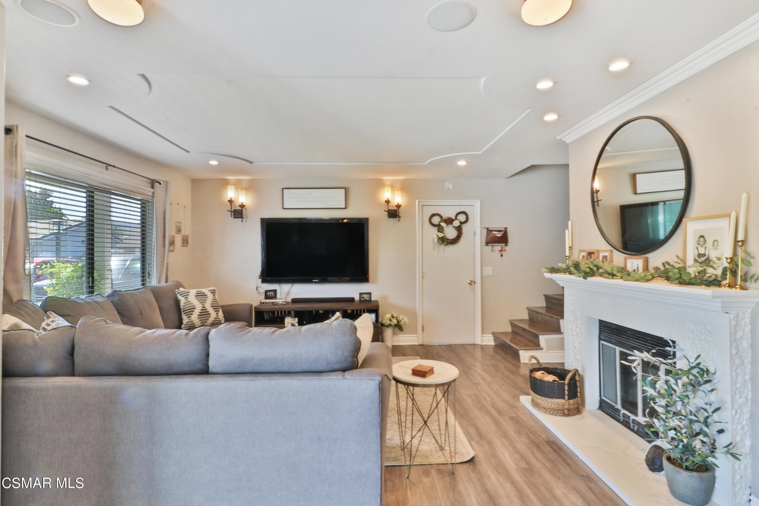 2346 Royal Avenue, Unit 9 Simi Valley, CA 93065 - Photo 8 of 31 a living room with furniture a fireplace and a flat screen tv