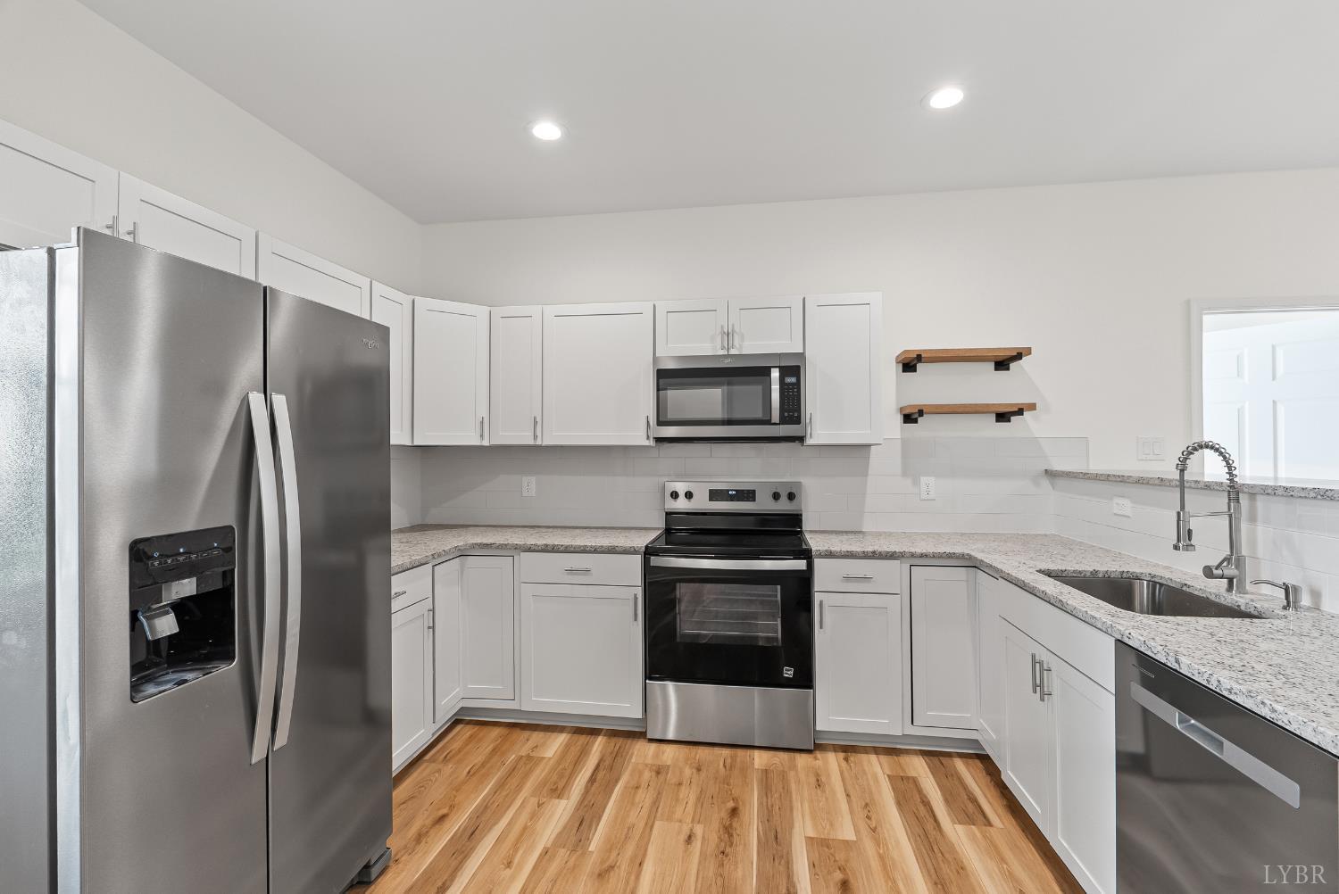 504 Amherst Street Lynchburg, VA 24504 - Photo 14 of 37 a kitchen with stainless steel appliances a refrigerator sink and microwave