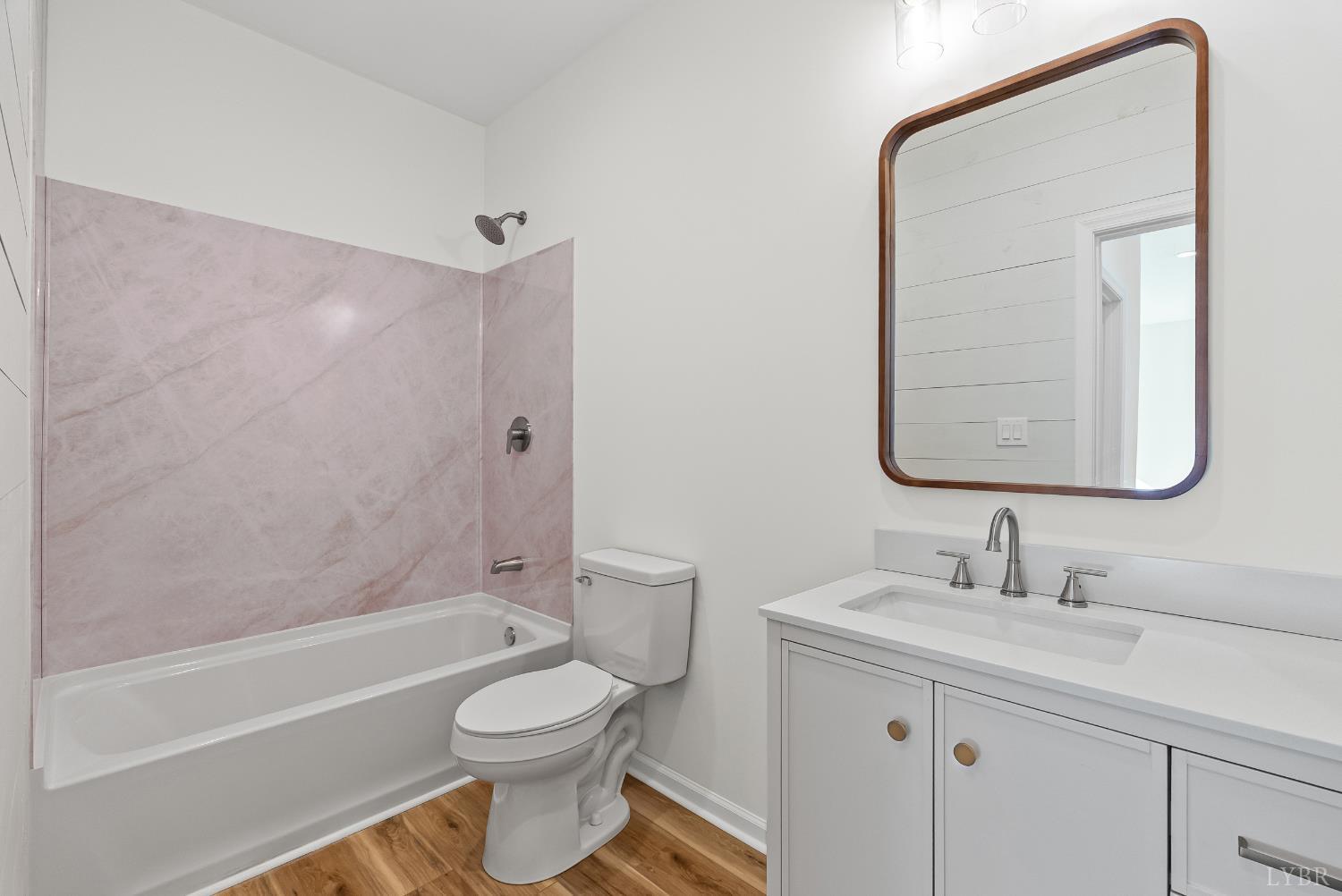 504 Amherst Street Lynchburg, VA 24504 - Photo 23 of 37 a bathroom with a toilet a sink a mirror a bathtub and vanity