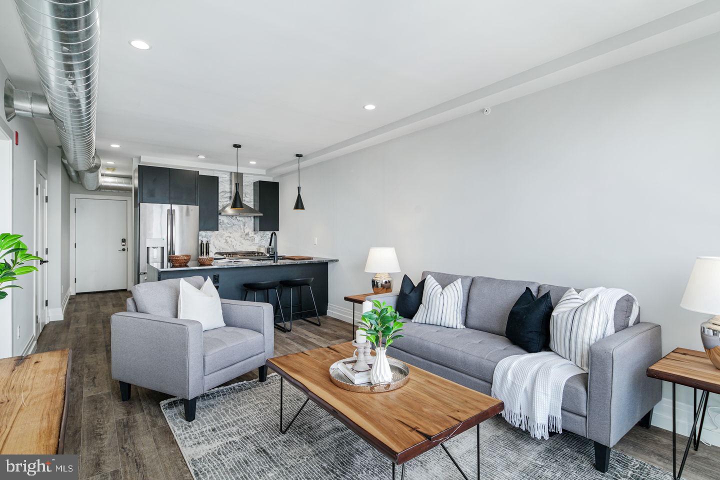 526 Brown Street, Unit 207 Philadelphia, PA 19123 - Photo 12 of 27 a living room with furniture and a dining table