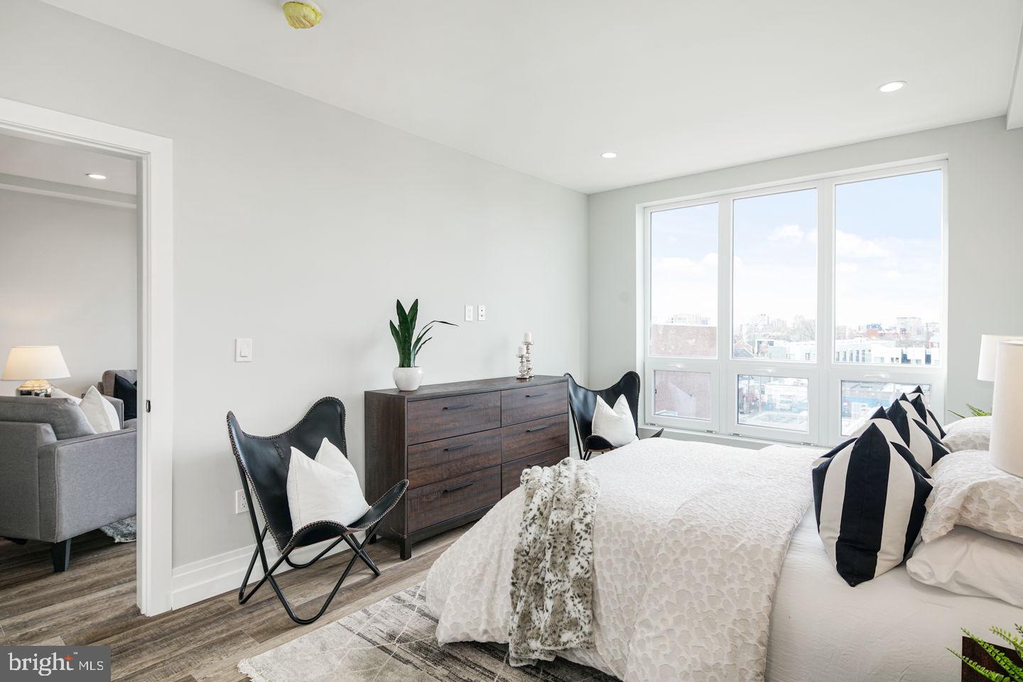 526 Brown Street, Unit 207 Philadelphia, PA 19123 - Photo 16 of 27 a bedroom with a bed chair and window