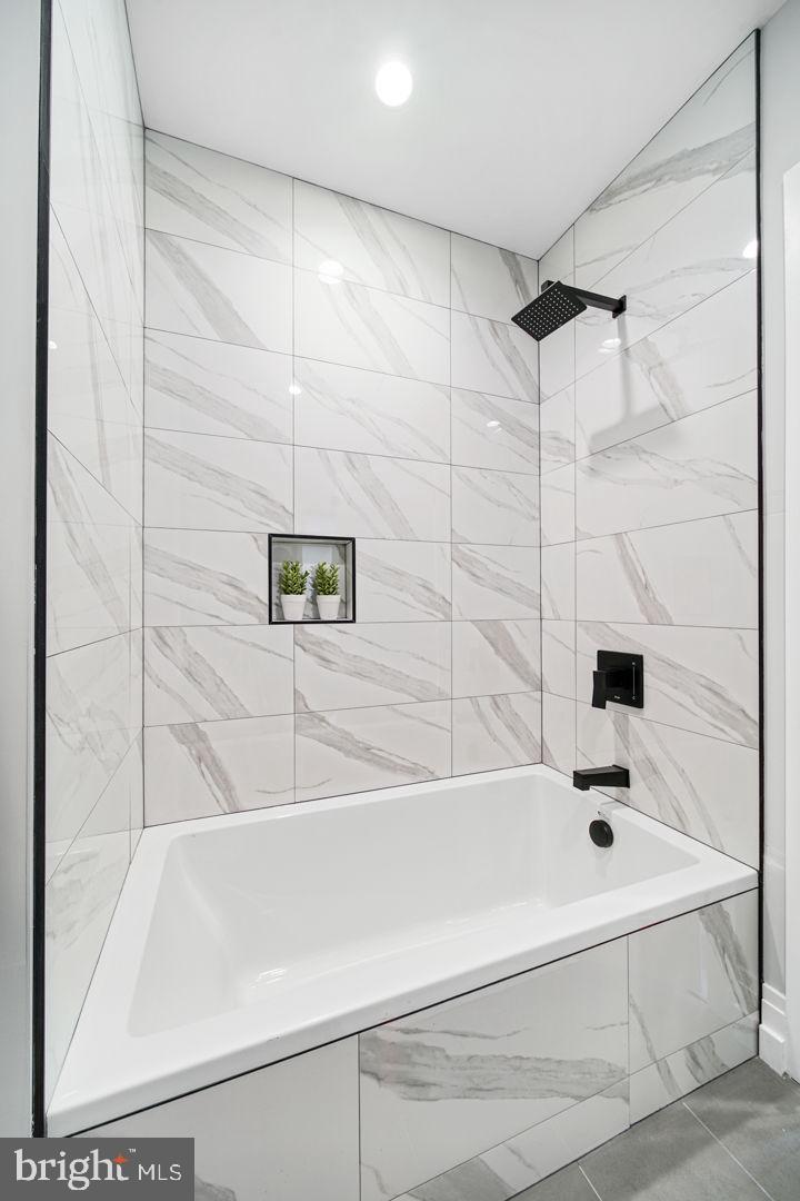 526 Brown Street, Unit 207 Philadelphia, PA 19123 - Photo 21 of 27 a bathroom with a bathtub and a shower