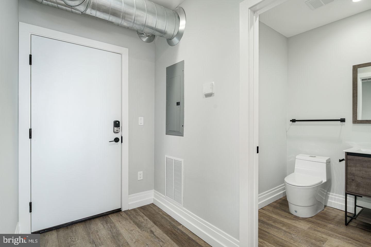 526 Brown Street, Unit 207 Philadelphia, PA 19123 - Photo 3 of 27 a white toilet sitting next to a bathroom sink