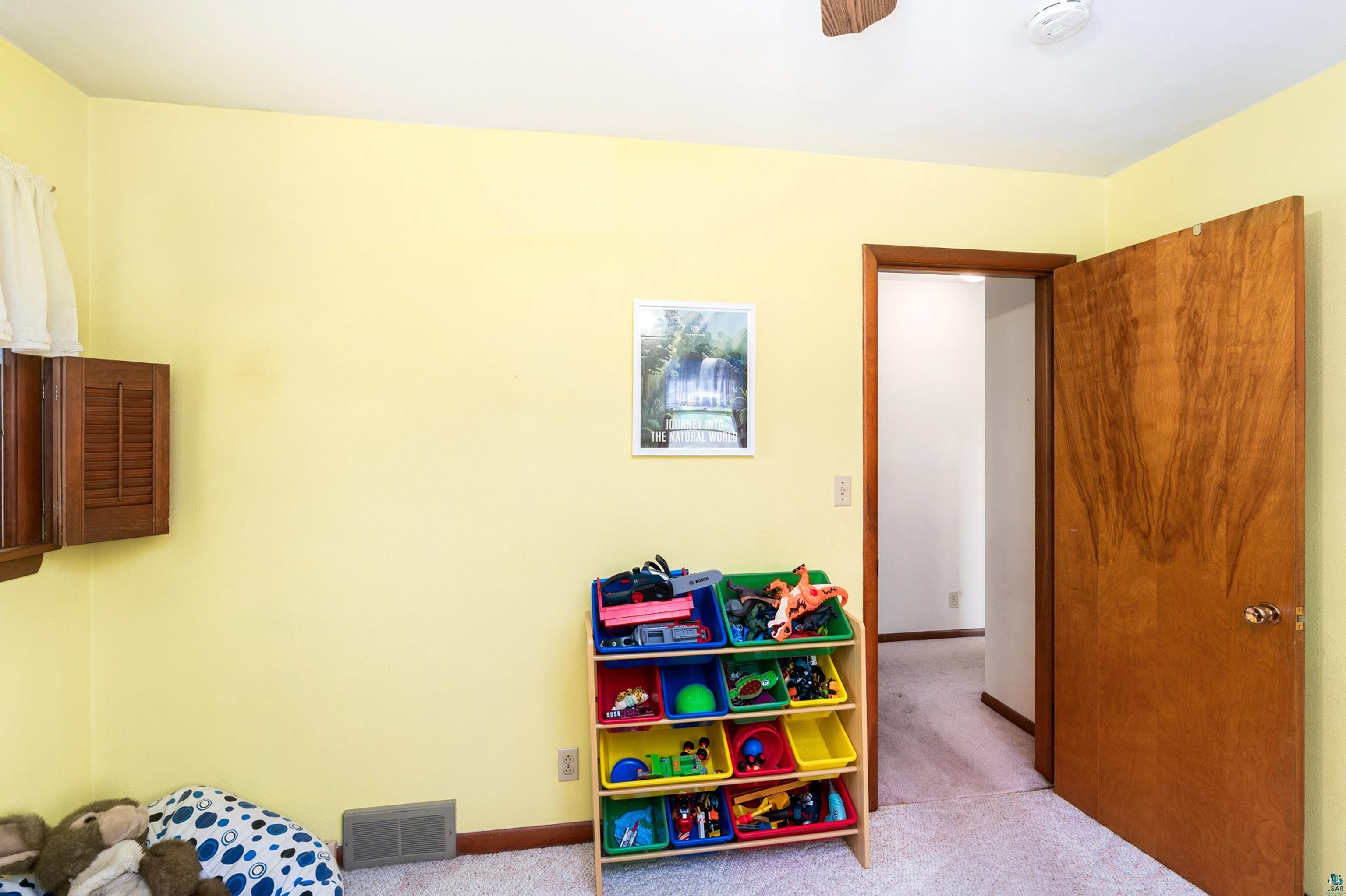 4808 Midway Road Duluth, MN 55811 - Photo 27 of 57 Room with yellow walls and light-colored carpeting