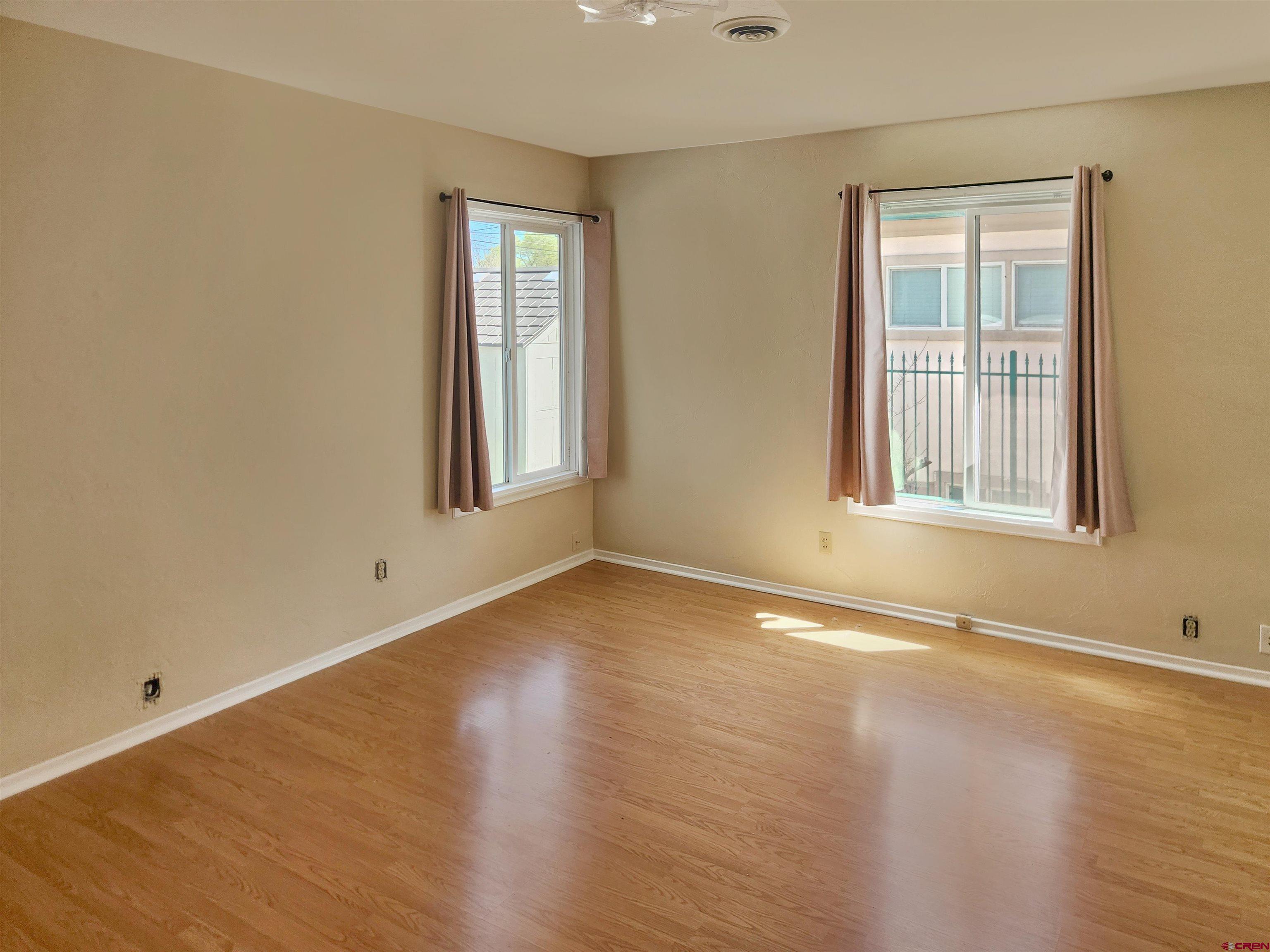 206 North Washington Street Cortez, CO 81321 - Photo 13 of 19 a view of an empty room with wooden floor and a window