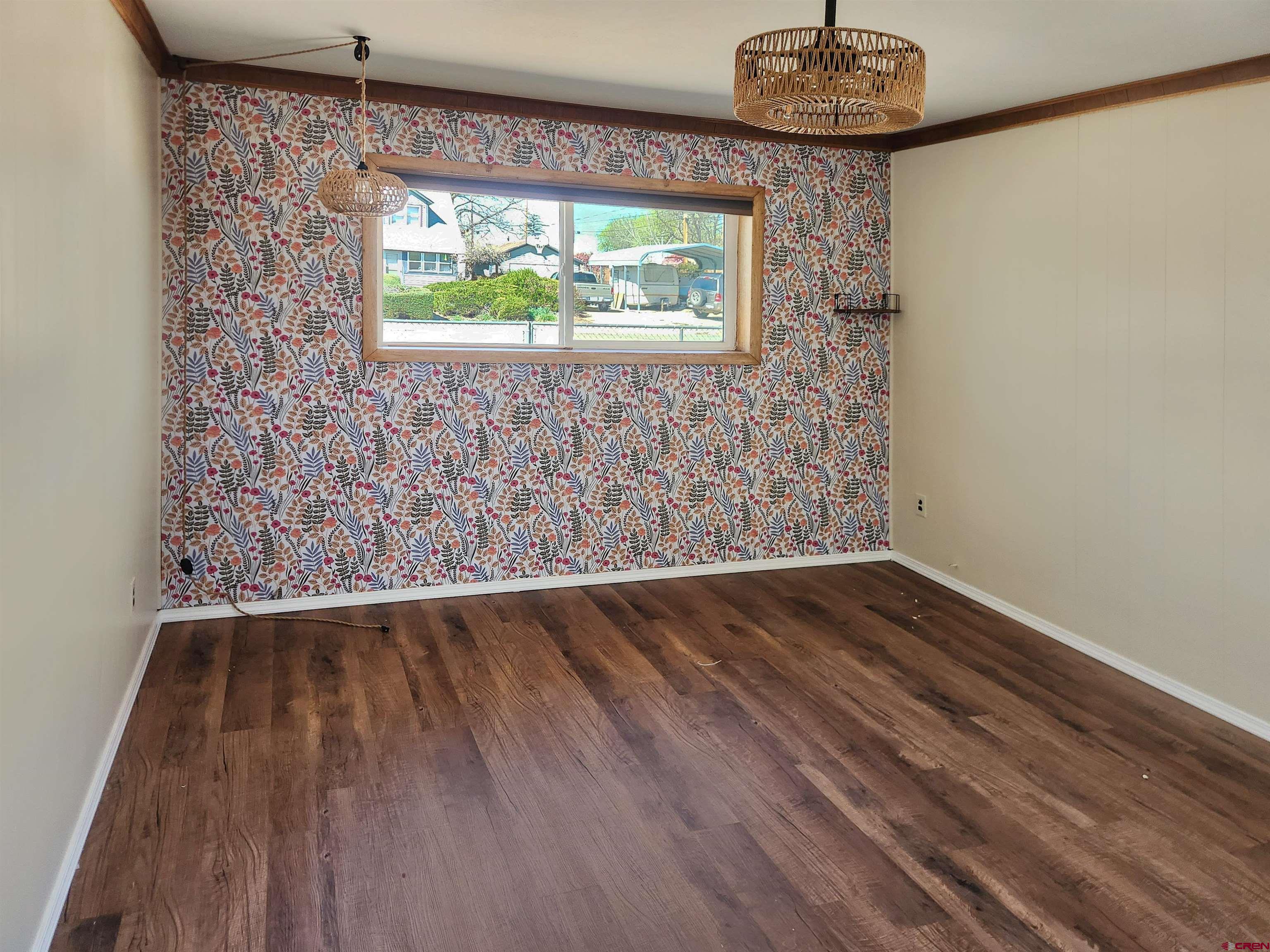 206 North Washington Street Cortez, CO 81321 - Photo 14 of 19 a view of an empty room with wooden floor and a window