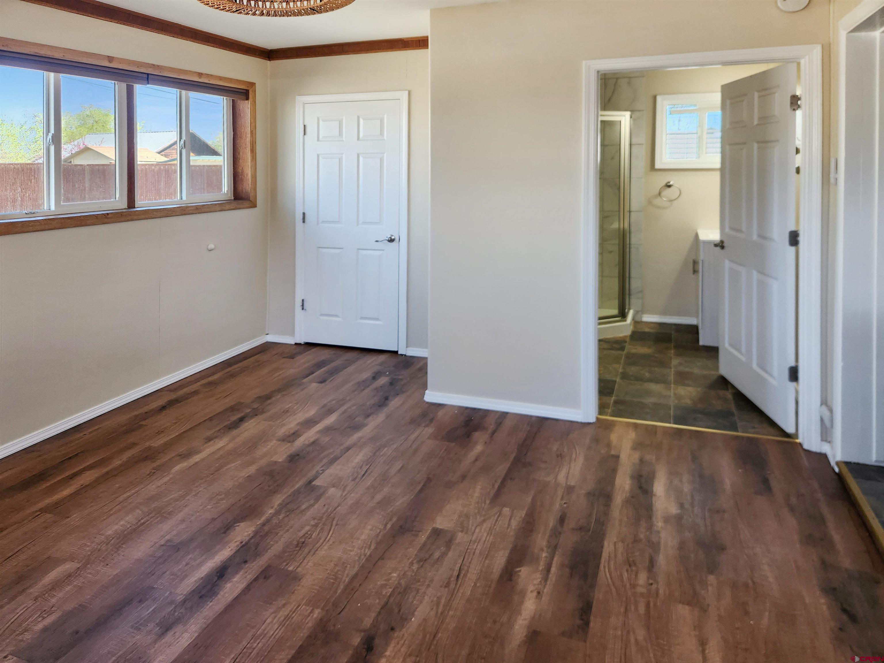 206 North Washington Street Cortez, CO 81321 - Photo 15 of 19 a view of an empty room with wooden floor and a window
