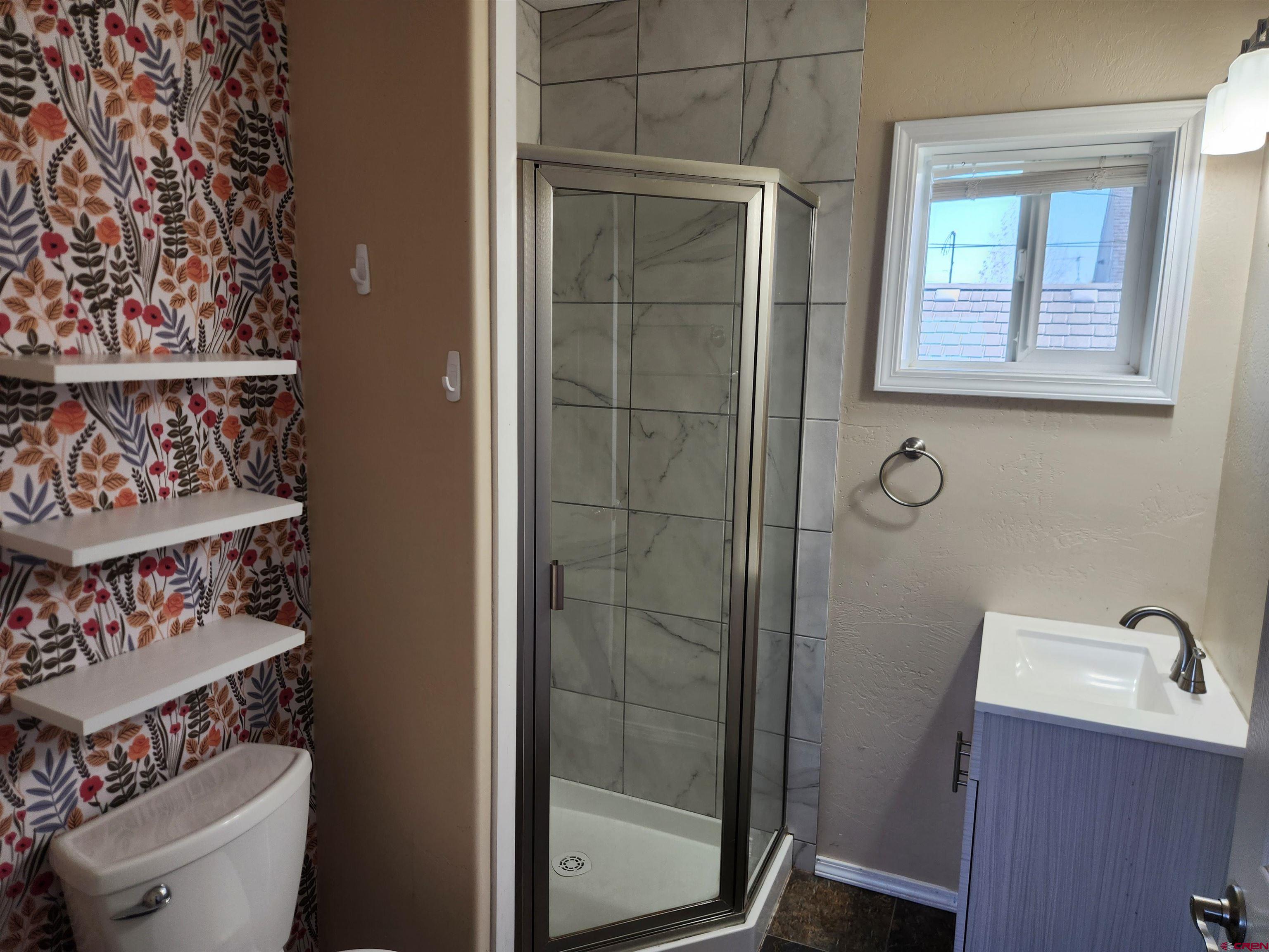 206 North Washington Street Cortez, CO 81321 - Photo 16 of 19 a bathroom with a toilet and a sink