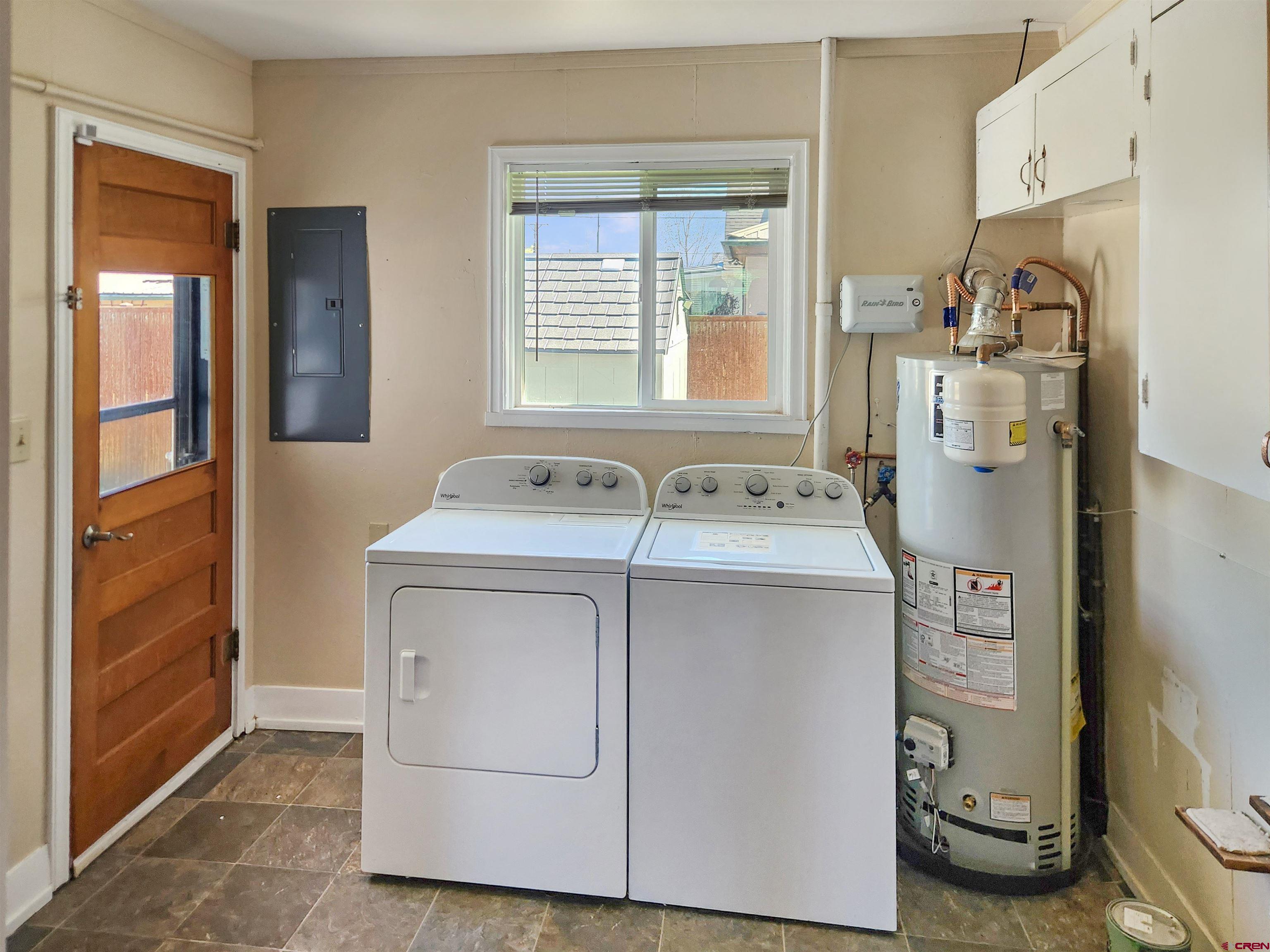206 North Washington Street Cortez, CO 81321 - Photo 17 of 19 a utility room with cabinets washer and dryer