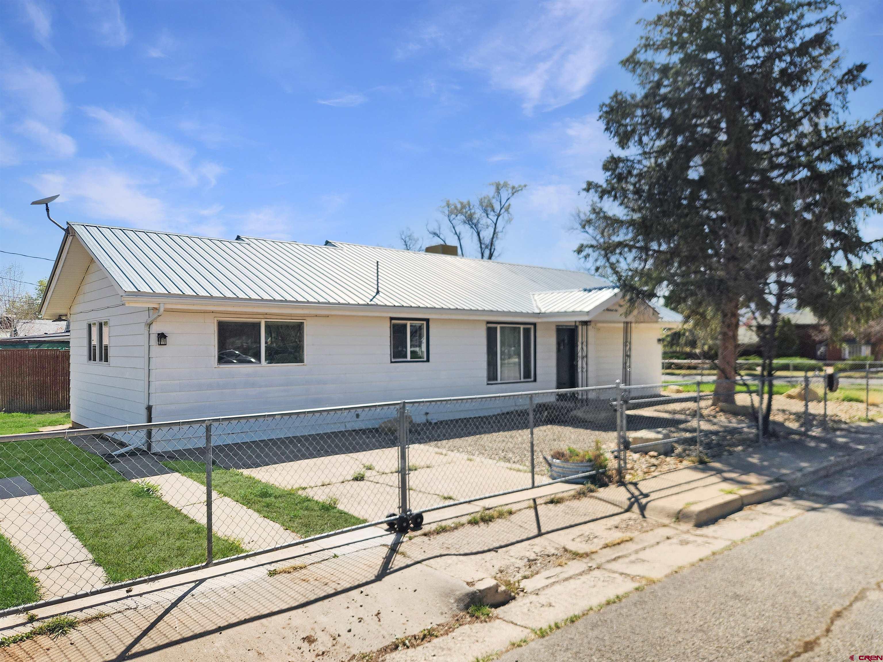 206 North Washington Street Cortez, CO 81321 - Photo 2 of 19 a front view of a house with a yard