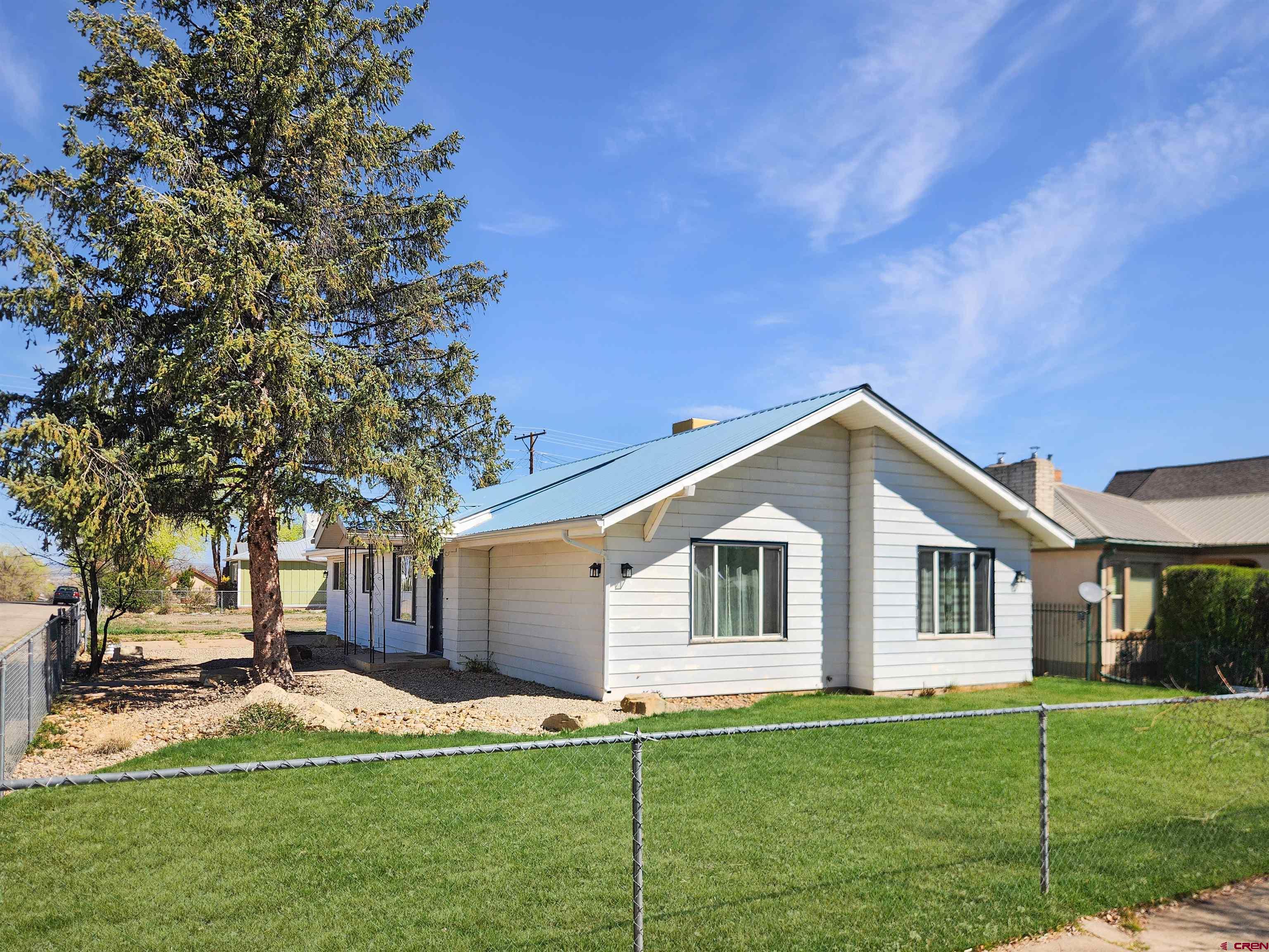 206 North Washington Street Cortez, CO 81321 - Photo 3 of 19 a view of a house with a yard