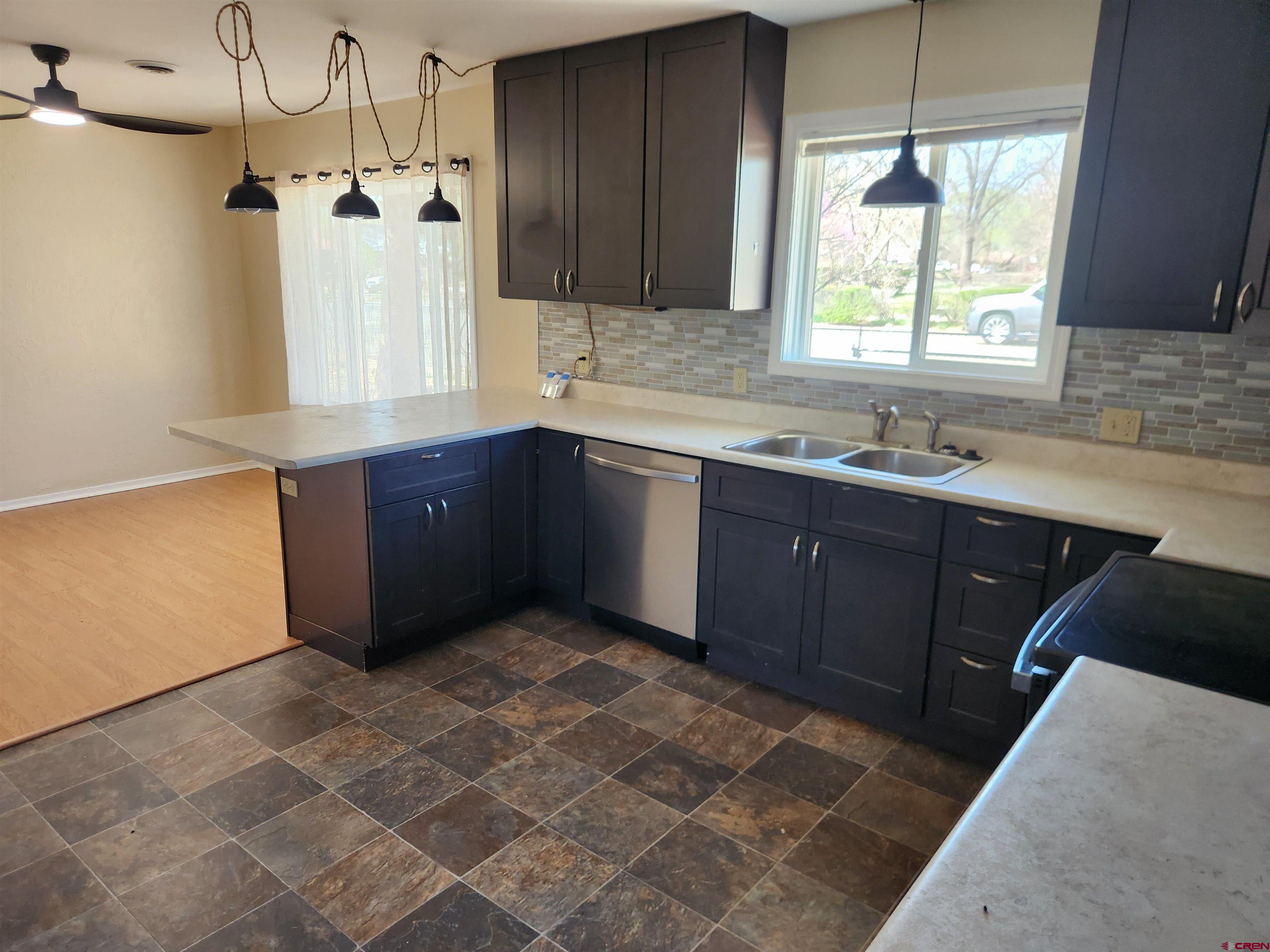 206 North Washington Street Cortez, CO 81321 - Photo 5 of 19 a kitchen with a sink a window and cabinets