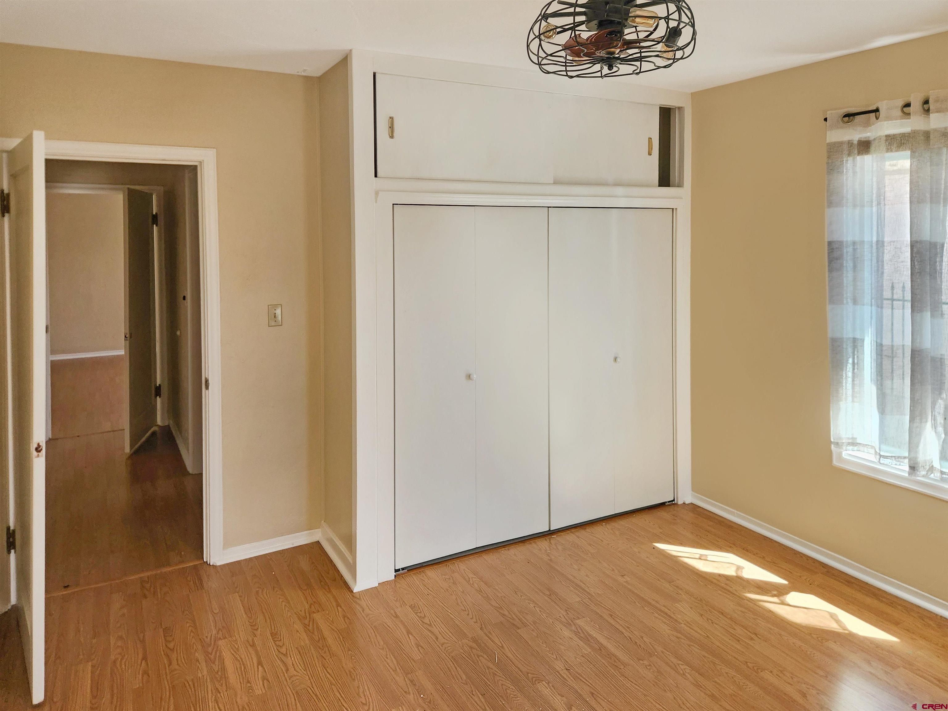 206 North Washington Street Cortez, CO 81321 - Photo 9 of 19 a view of an empty room with window and wooden floor