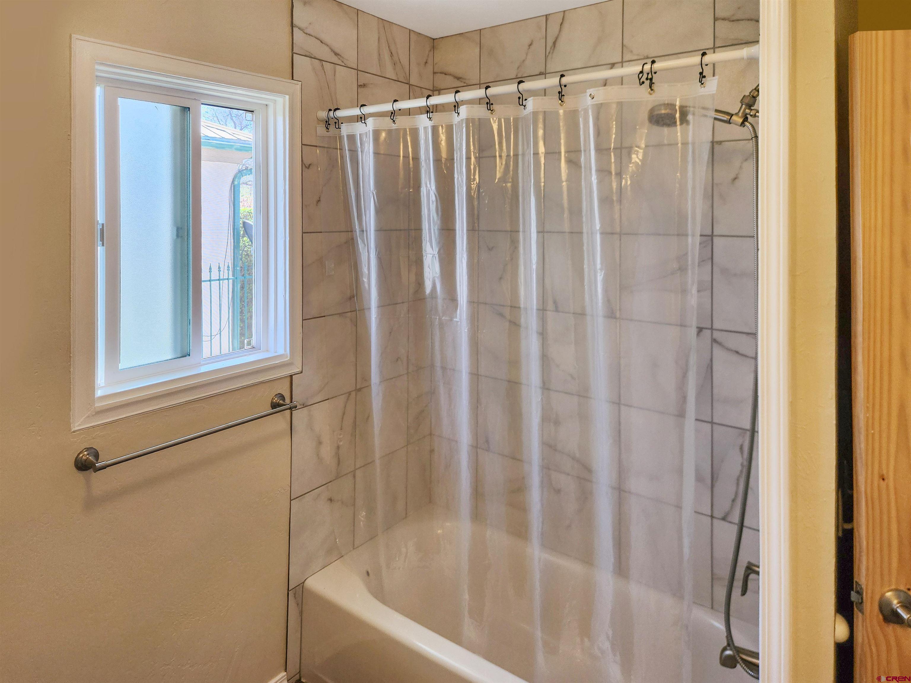 206 North Washington Street Cortez, CO 81321 - Photo 10 of 19 a bathroom with a shower and a tub