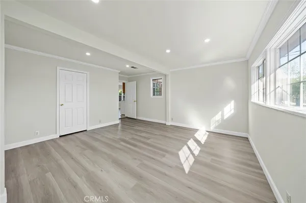 a view of empty room with wooden floor