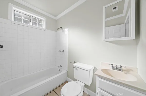 a bathroom with a granite countertop toilet a sink and bathtub