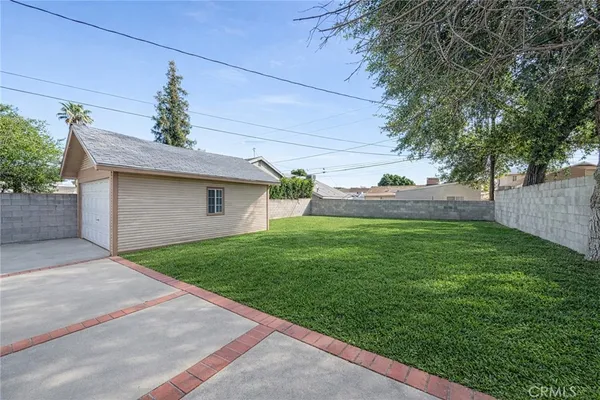 a front view of house with a garden