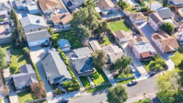 an aerial view of residential houses with outdoor space