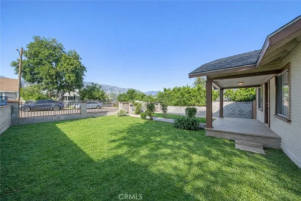 a view of a house with a yard and a garden