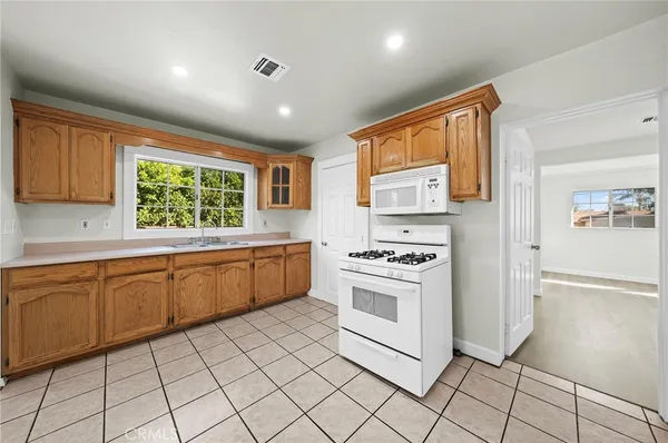 a kitchen with granite countertop cabinets and window