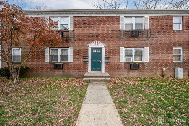 front view of a brick house with a large windows