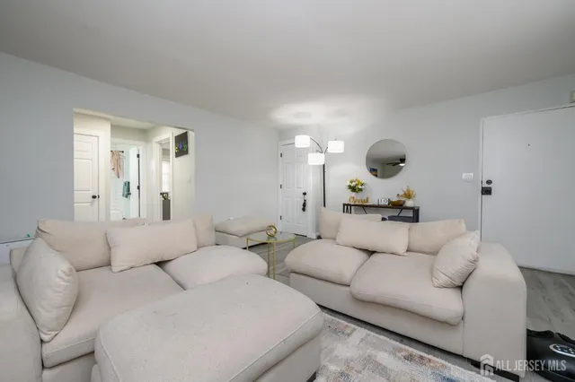 a living room with furniture and a mirror