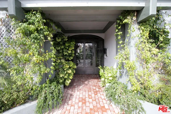 a front view of a house with lots of green space
