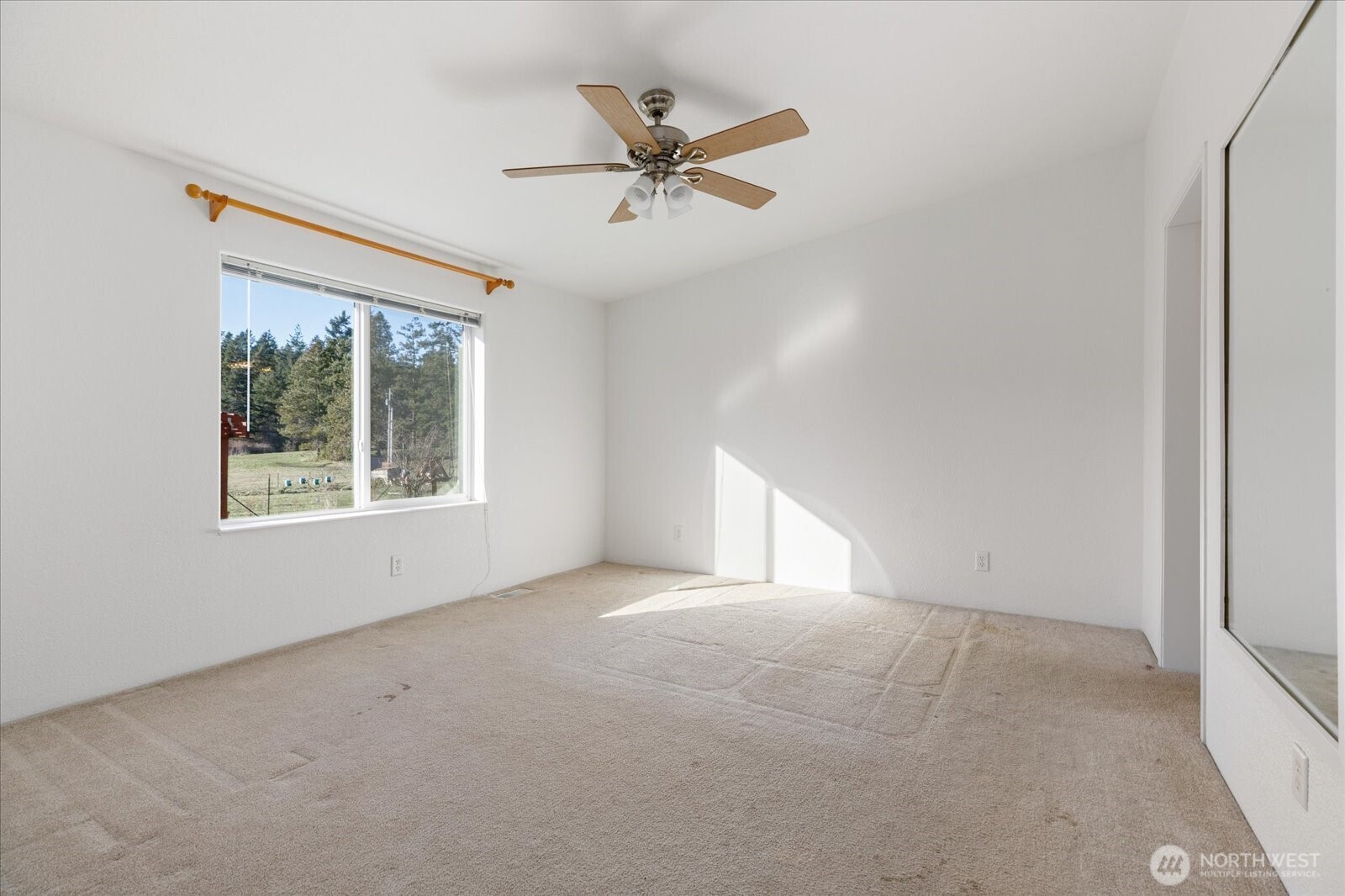 4522 Monkey Hill Road Oak Harbor, WA 98277 - Photo 14 of 40 an empty room with a window and a ceiling fan