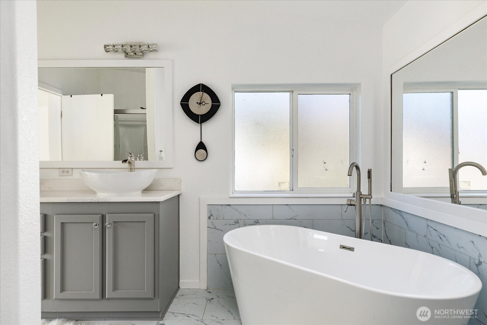 4522 Monkey Hill Road Oak Harbor, WA 98277 - Photo 17 of 40 a bathroom with a tub sink and mirror