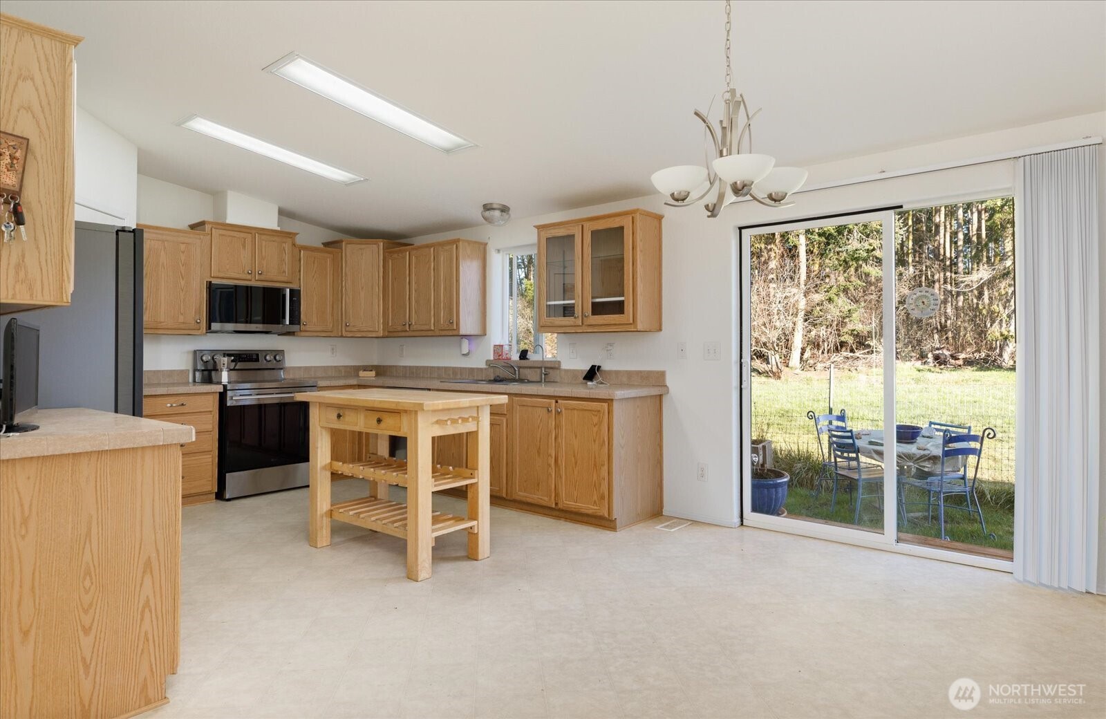 4522 Monkey Hill Road Oak Harbor, WA 98277 - Photo 7 of 40 a kitchen with stainless steel appliances a stove a sink refrigerator and a view of living room