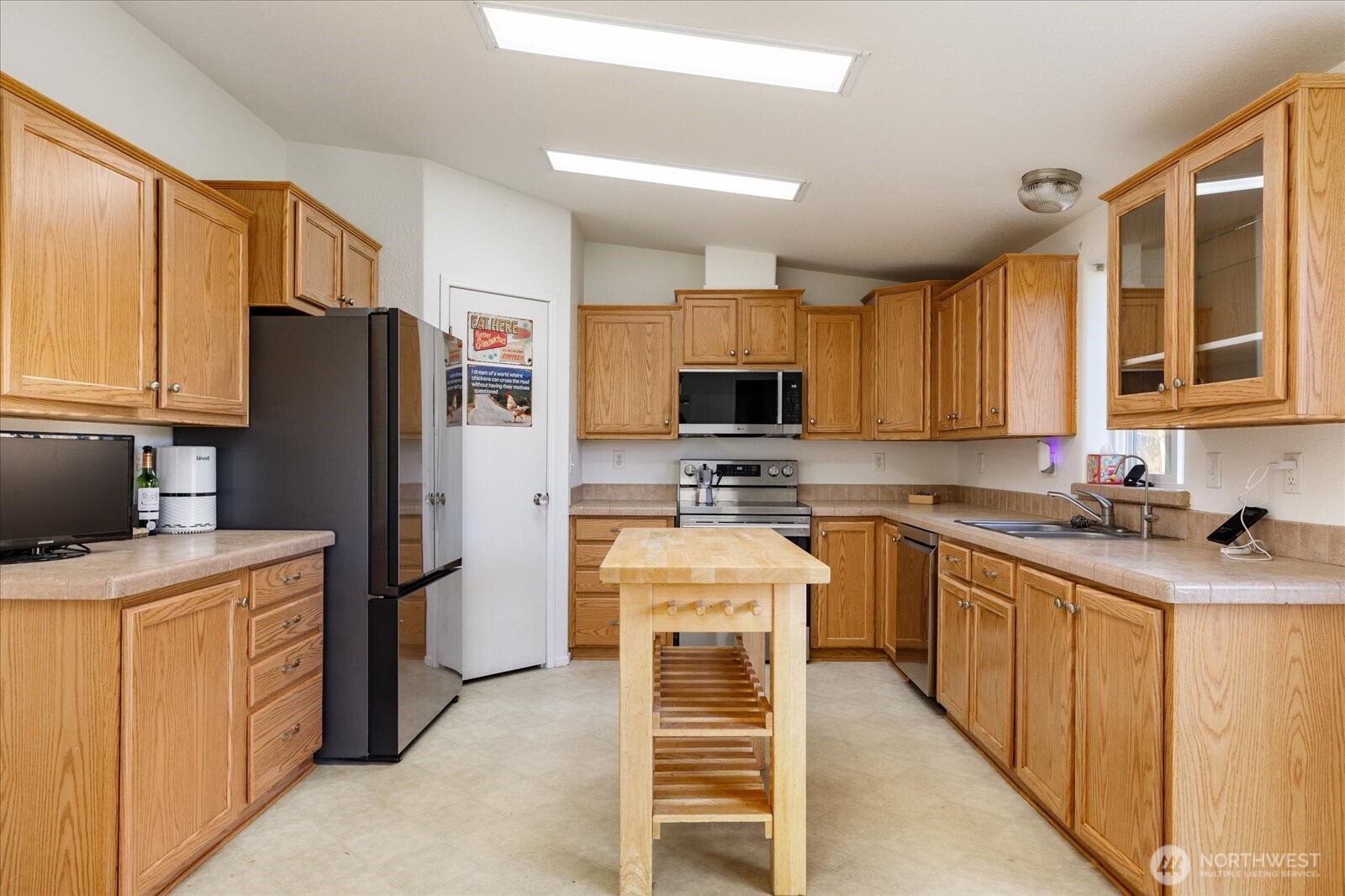 4522 Monkey Hill Road Oak Harbor, WA 98277 - Photo 8 of 40 a kitchen with stainless steel appliances granite countertop a refrigerator stove microwave and sink