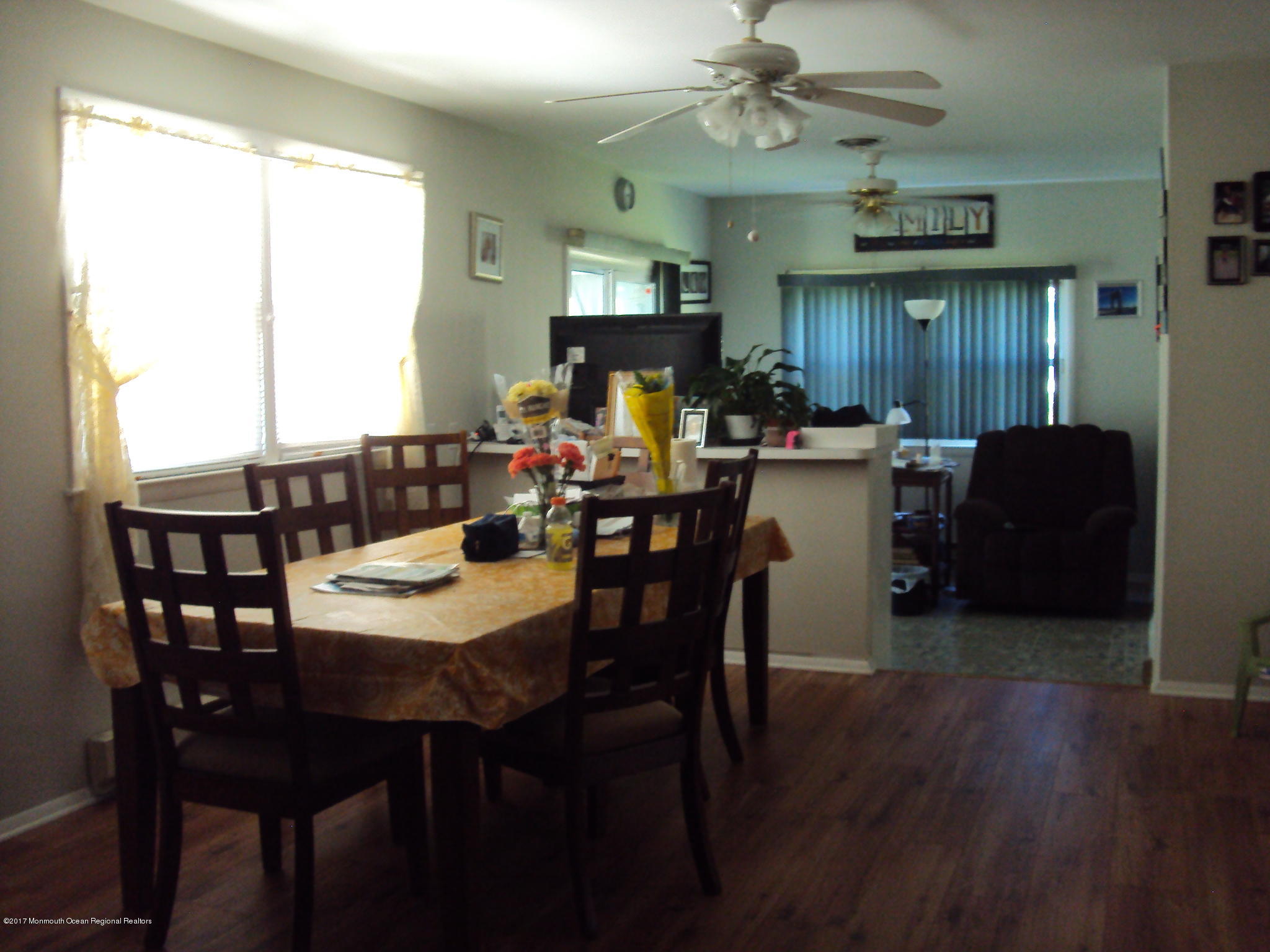 38 Hartford Road, Unit 73 Whiting, NJ 08759 - Photo 16 of 25 a view of a dining room with furniture window and wooden floor