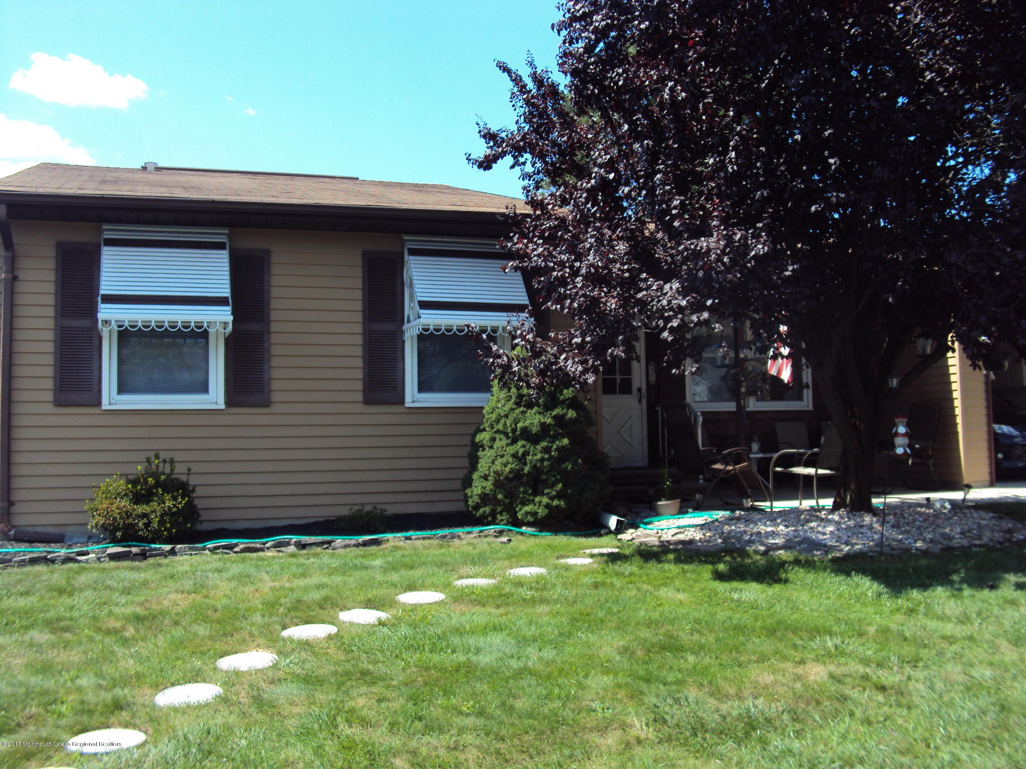 38 Hartford Road, Unit 73 Whiting, NJ 08759 - Photo 2 of 25 a front view of a house with a garden