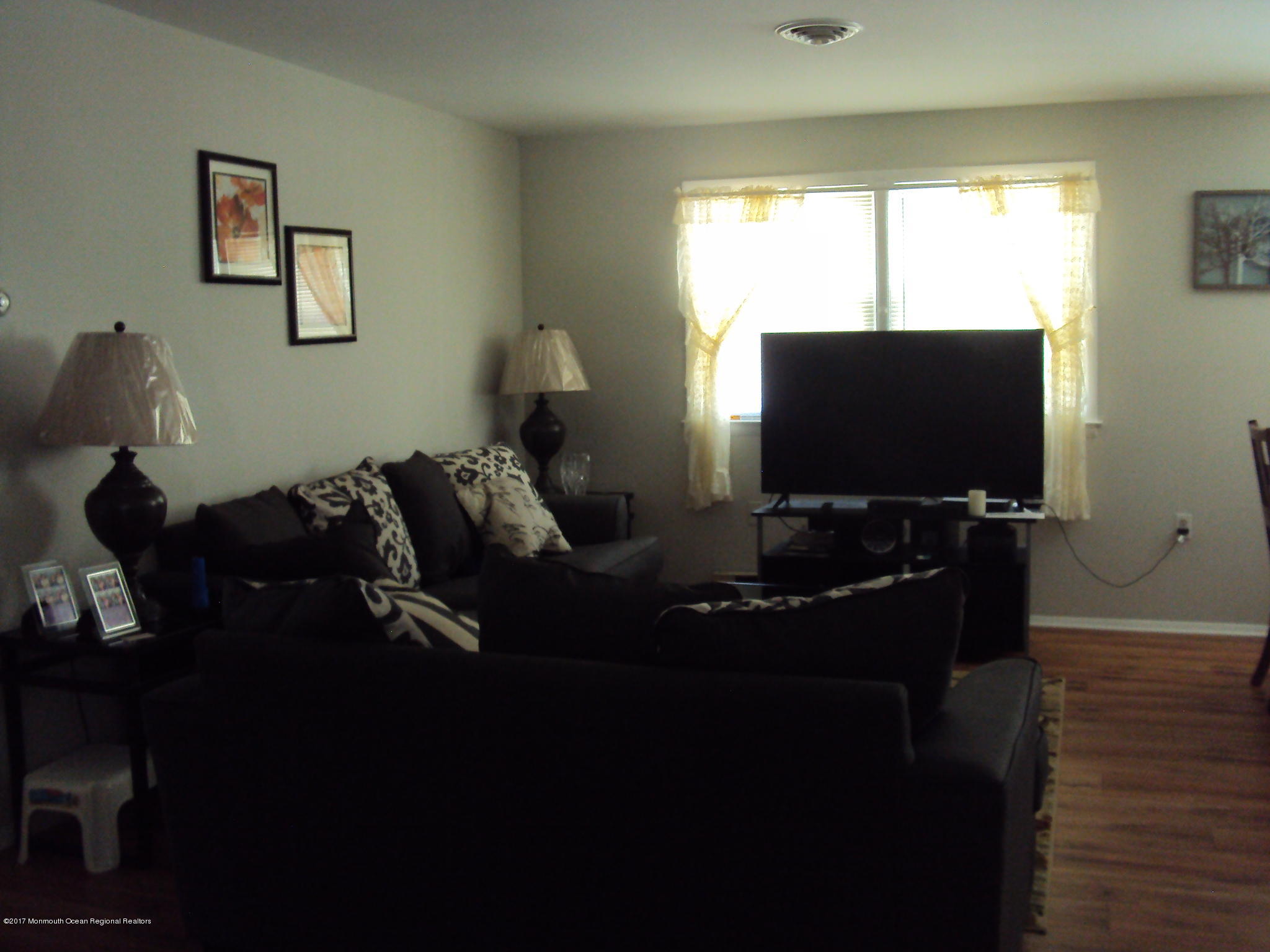 38 Hartford Road, Unit 73 Whiting, NJ 08759 - Photo 22 of 25 a living room with furniture and a flat screen tv