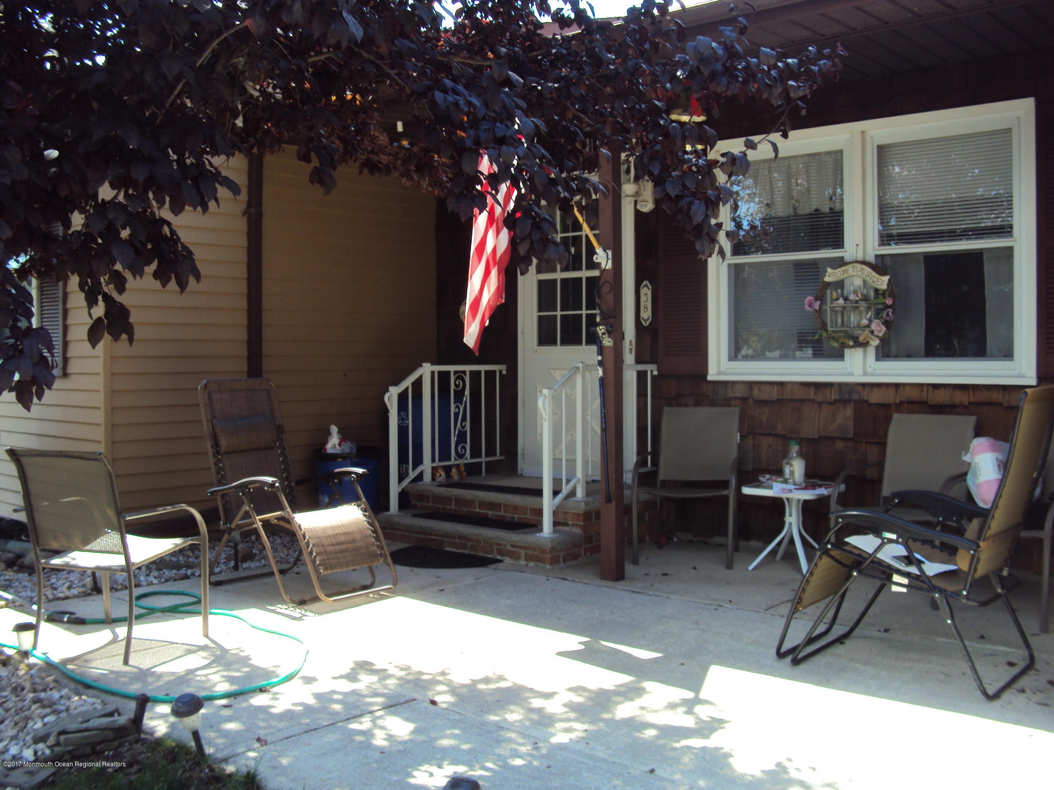 38 Hartford Road, Unit 73 Whiting, NJ 08759 - Photo 3 of 25 a view of patio with table and chairs and potted plants