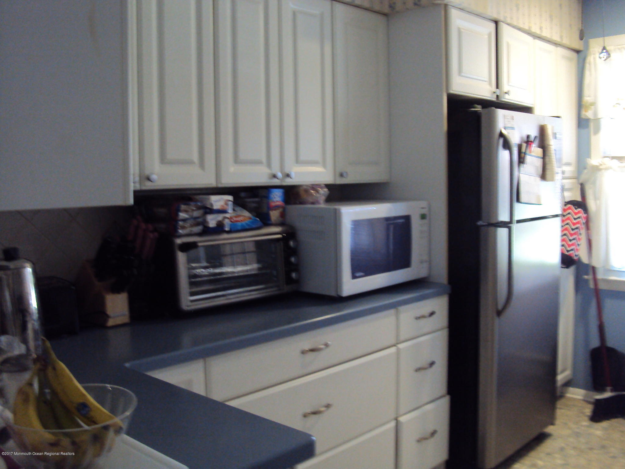 38 Hartford Road, Unit 73 Whiting, NJ 08759 - Photo 9 of 25 a kitchen with stainless steel appliances granite countertop a refrigerator a stove and a sink with wooden floor
