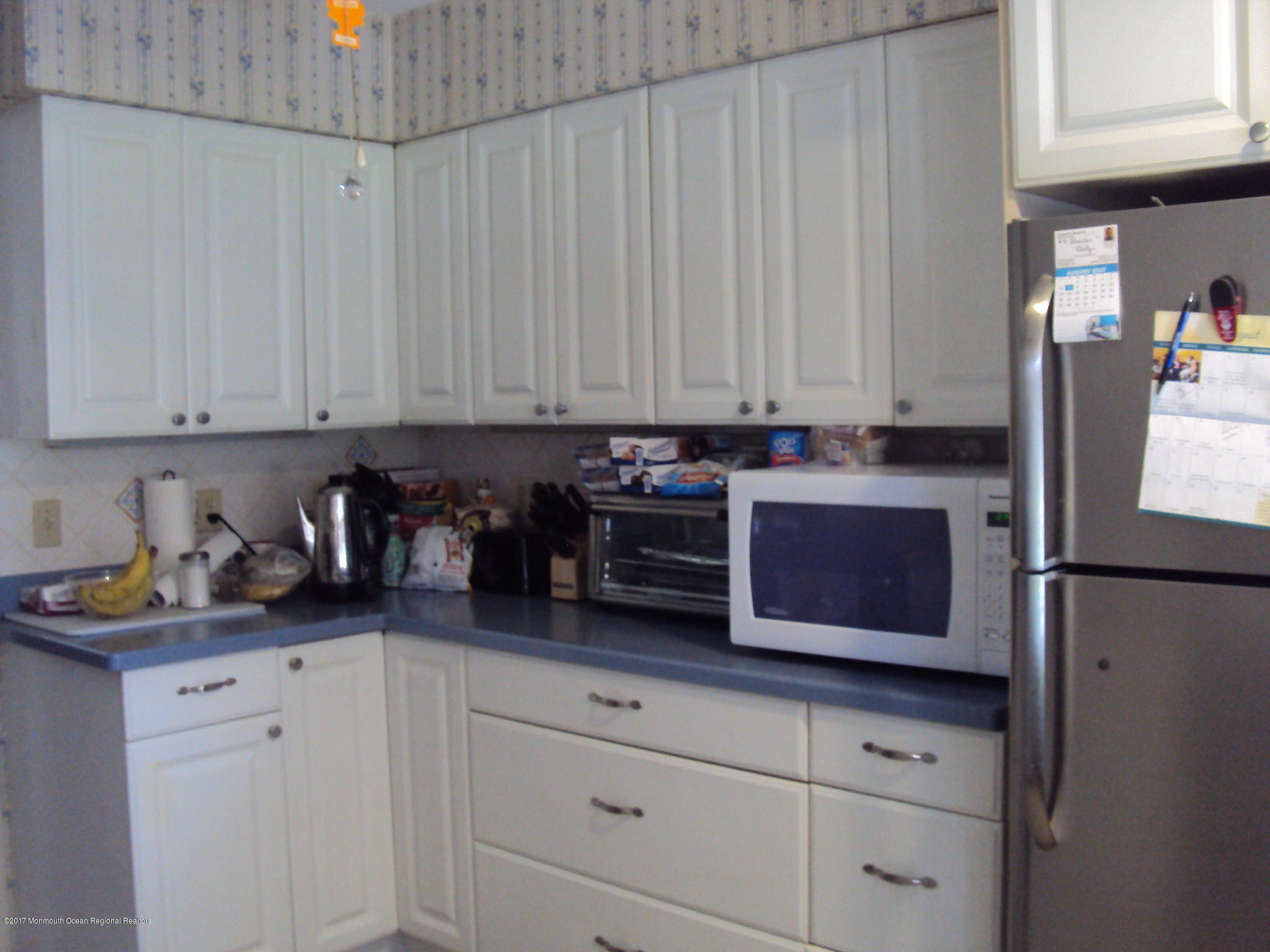 38 Hartford Road, Unit 73 Whiting, NJ 08759 - Photo 10 of 25 a kitchen with stainless steel appliances granite countertop a refrigerator a stove and white cabinets