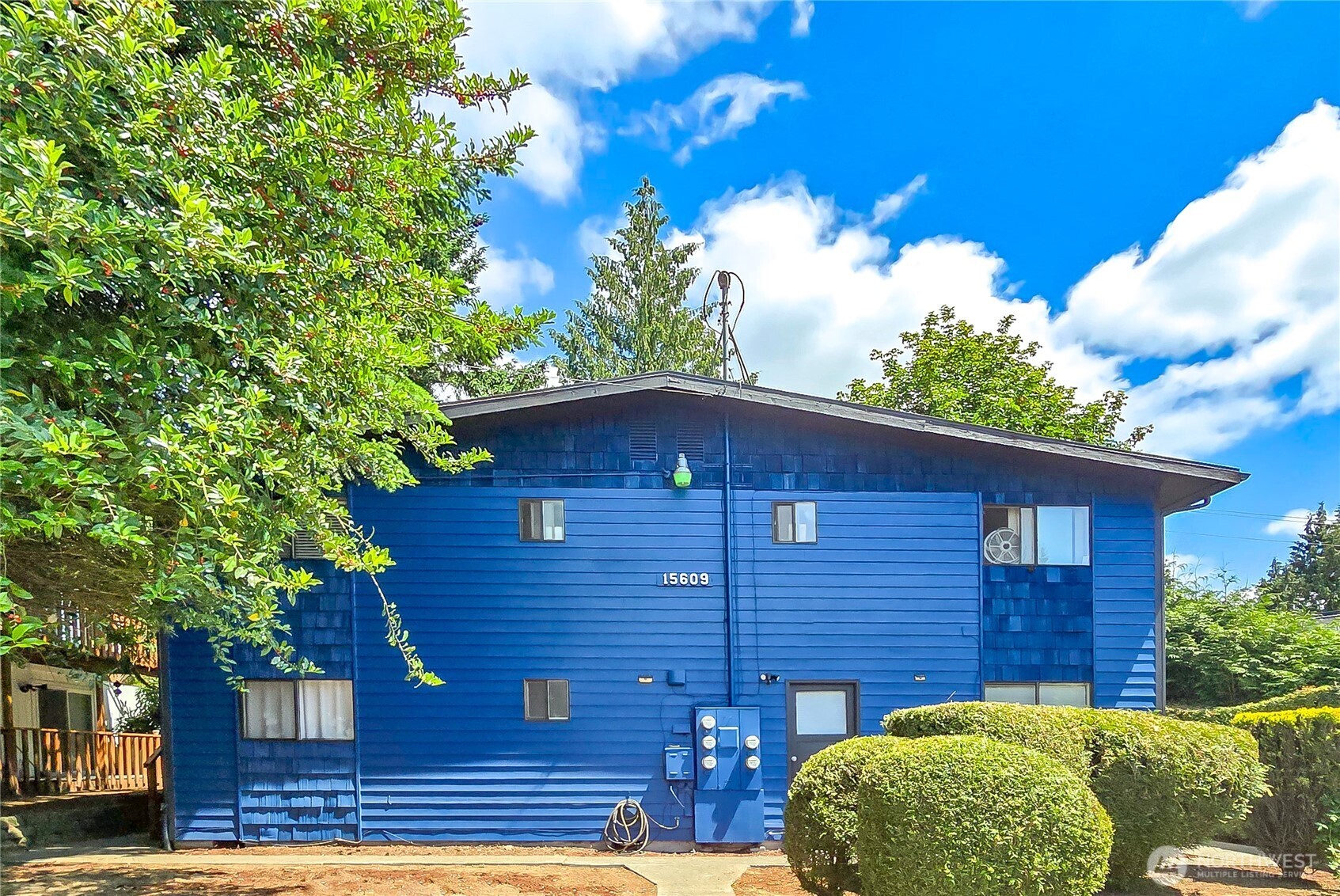 15609 8th Avenue Southwest Burien, WA 98166 - Photo 1 of 26 a view of a brick house with a large tree