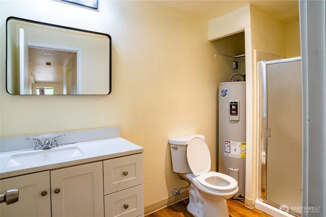 a bathroom with a toilet sink and mirror